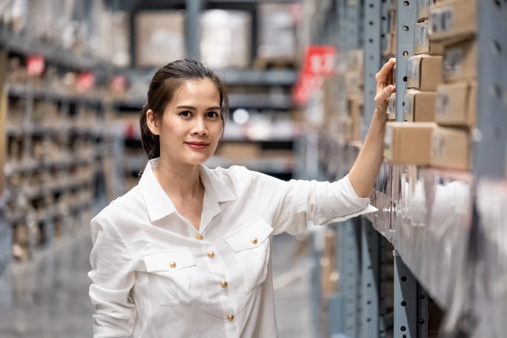 Young female worker considering traditional inventory management