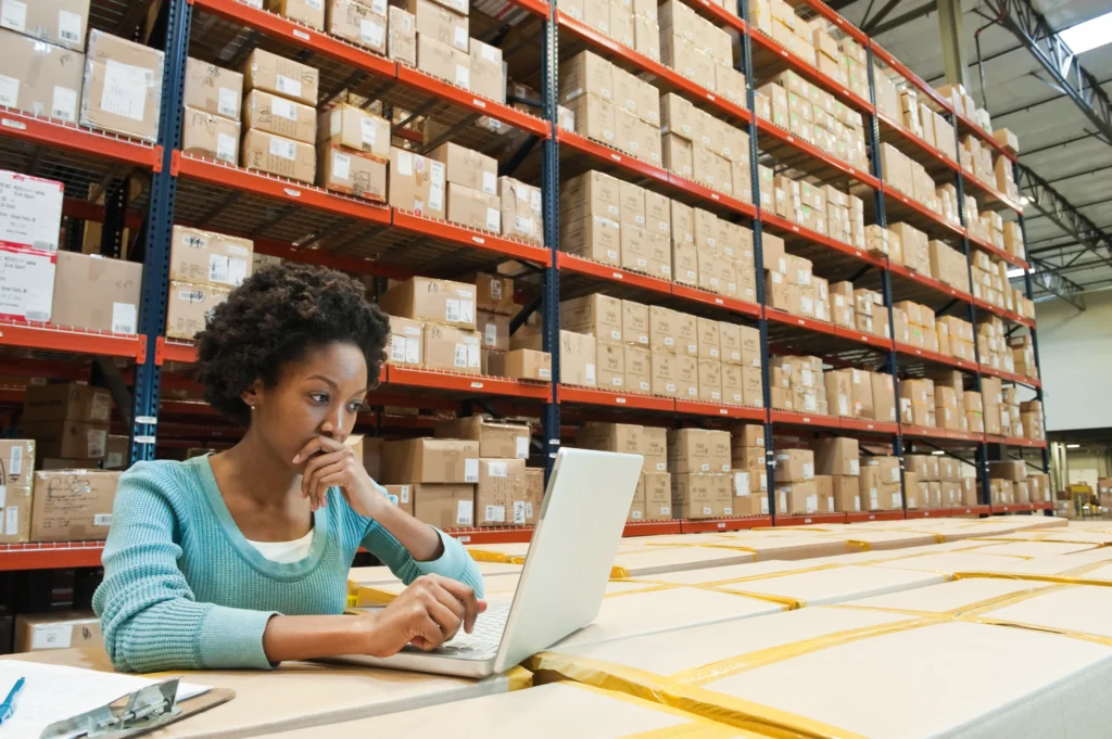 Female warehouse worker looking at warehouse mapping