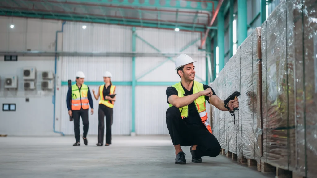 Warehouse worker scanning barcodes thinking about warehouse labour costs