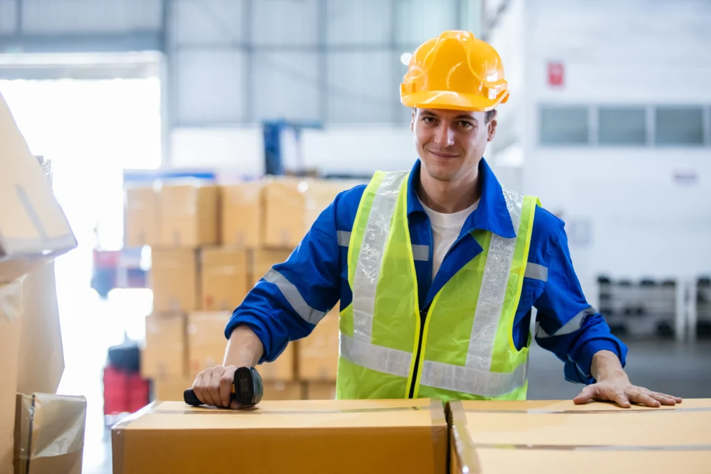 Male worker in warehouse working on Goods In