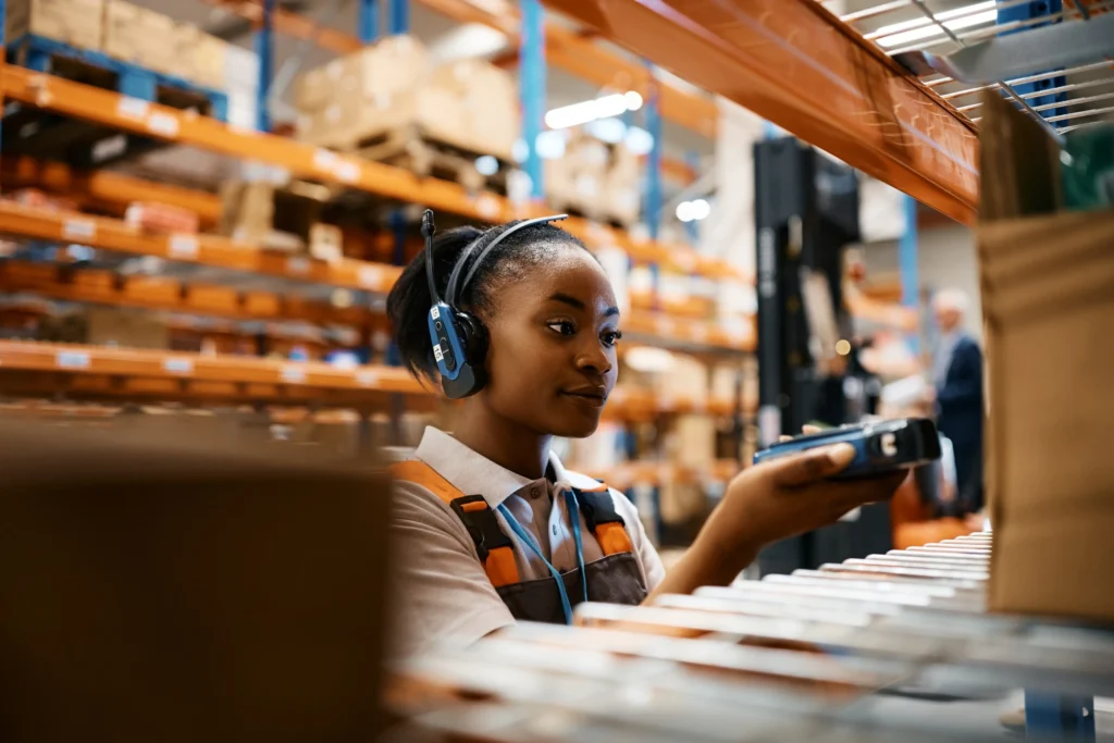 young woman voice picking warehouse